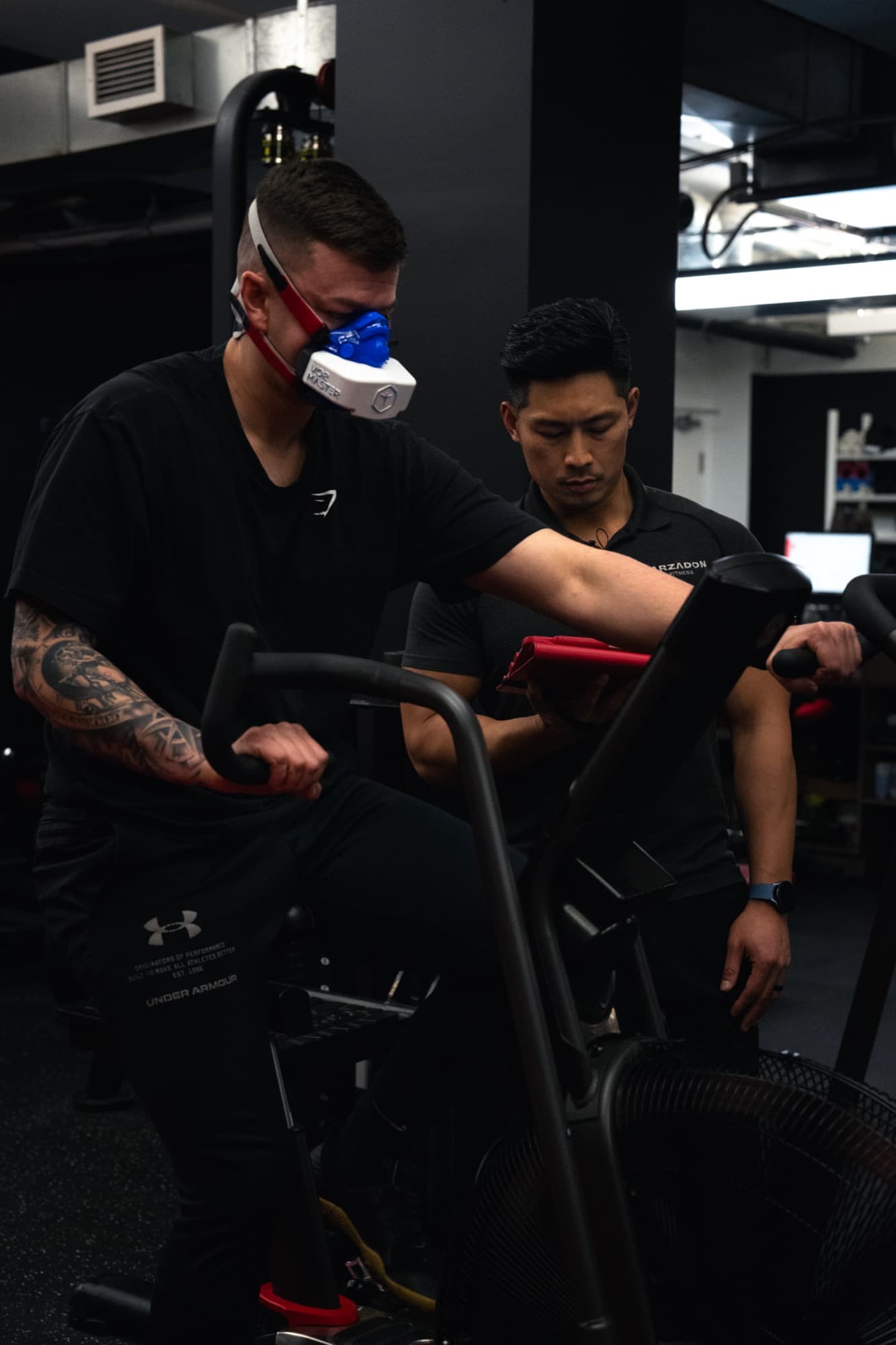 Female client performing barbell exercise during body composition assessment at Arzadon Fitness Toronto